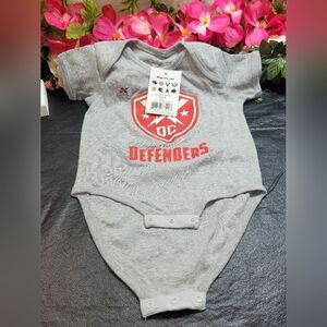 NWT DC DEFENDERS ONESIE 18M